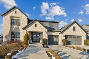 View of front facade with a garage and french doors