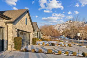 View of side of home featuring a mountain view and a garage