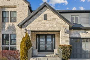 Property entrance featuring a garage and french doors