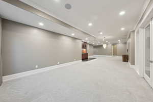 Basement with light colored carpet