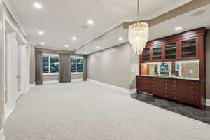 Interior space with dark tile  and a notable chandelier