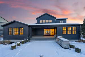 Snow covered rear of property featuring an outdoor kitchen