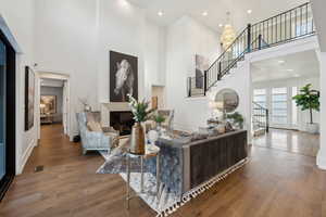 Living room featuring a high ceiling and hardwood / wood-style floors