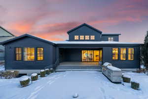 View of snow covered rear of property