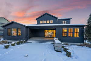 Snow covered house with a porch