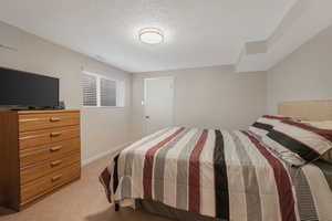 Fourth Bedroom with a textured ceiling and carpet flooring