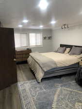 Bedroom featuring ornamental molding and dark hardwood / wood-style floors