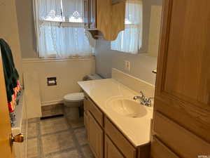 Bathroom with vanity, tile patterned floors, and toilet