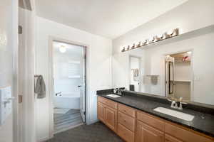 Bathroom featuring a bathing tub, vanity, and a textured ceiling