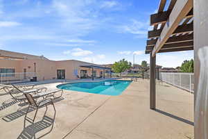 View of pool with a patio and a pergola