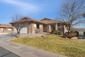 Single story home with an attached garage, driveway, brick siding, and a tile roof