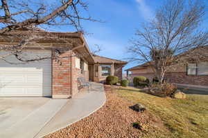 View of front of property with a garage and a front yard