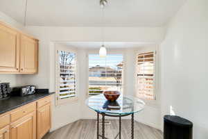 Kitchen featuring pendant lighting, light wood-type flooring, and light brown cabinets