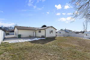 Back of house with a yard and a patio area