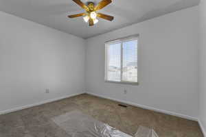 Spare room with carpet floors and ceiling fan