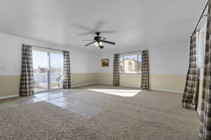 Spare room featuring a healthy amount of sunlight and ceiling fan