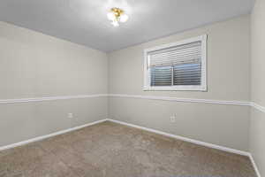 Empty room featuring carpet flooring