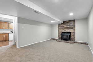 Unfurnished living room with sink and carpet flooring