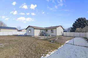 Rear view of property with a lawn