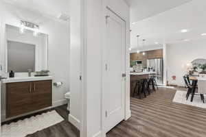 Bathroom featuring vanity, hardwood / wood-style floors, and toilet