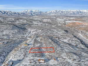 Snowy aerial view featuring a mountain view