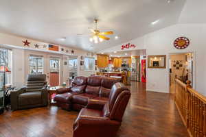 Living room with ceiling fan, french doors, lofted ceiling, and dark hardwood / wood-style flooring