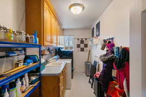 Kitchen featuring sink and washing machine and dryer