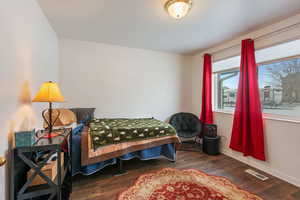 Bedroom with dark wood-type flooring