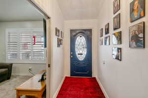 Doorway featuring carpet flooring