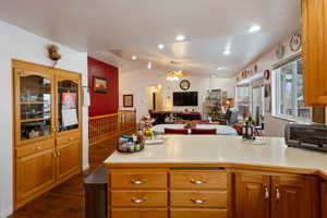 Kitchen with vaulted ceiling, ceiling fan, and dark hardwood / wood-style flooring