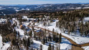 Snowy aerial view featuring a mountain view