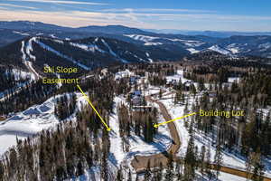 Snowy aerial view featuring a mountain view