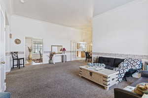 Living room featuring light carpet and crown molding