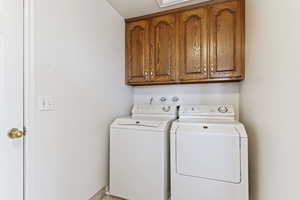 Clothes washing area with washing machine and dryer and cabinets