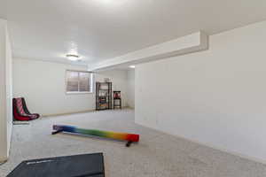 Exercise area with carpet and a textured ceiling