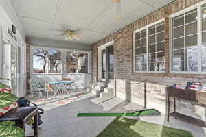 Sunroom featuring ceiling fan