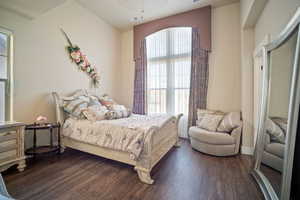 Bedroom with dark wood-type flooring