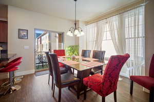 Dining space featuring a notable chandelier and hardwood / wood-style flooring