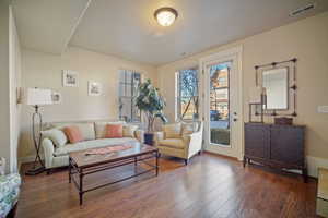 Living room with dark wood-type flooring