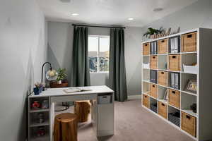 Carpeted home office with a textured ceiling