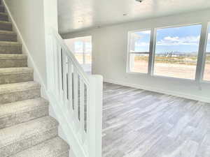 Stairway with wood-type flooring and a textured ceiling