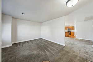 Unfurnished room with dark carpet