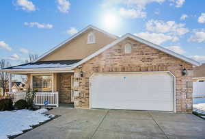 Front of property with a garage and a porch