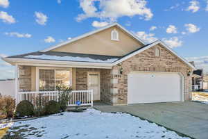 View of front of home with a garage and a porch