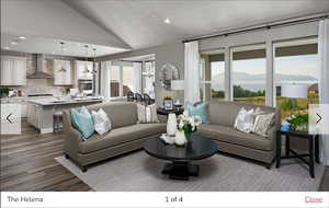 Living room featuring a mountain view, a wealth of natural light, lofted ceiling, and a textured ceiling