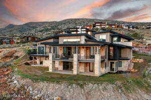 Back house at dusk featuring a mountain view