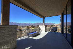 View of patio with a balcony and a mountain view