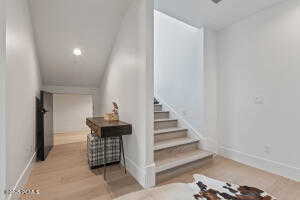 Staircase with hardwood / wood-style floors