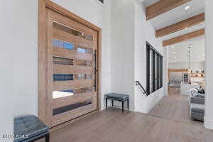 Interior space featuring beam ceiling and light hardwood / wood-style flooring