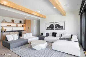 Living room with beam ceiling and light hardwood / wood-style floors